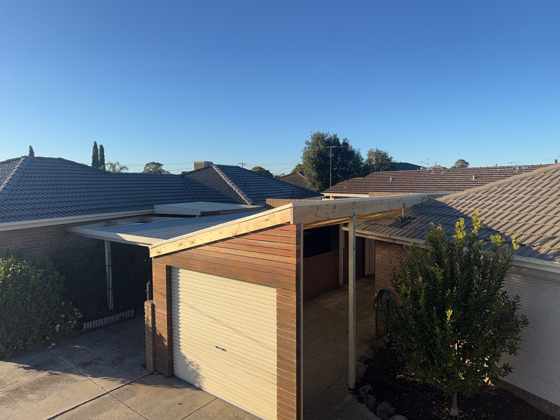 Timber-clad carport with colorbond roof
